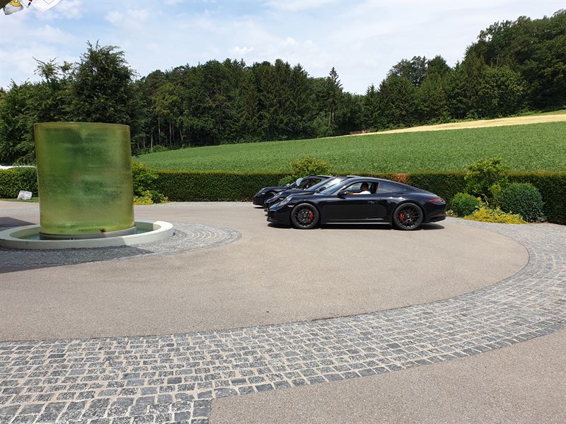 Three Porsche 911s — wider angle at hotel arrival