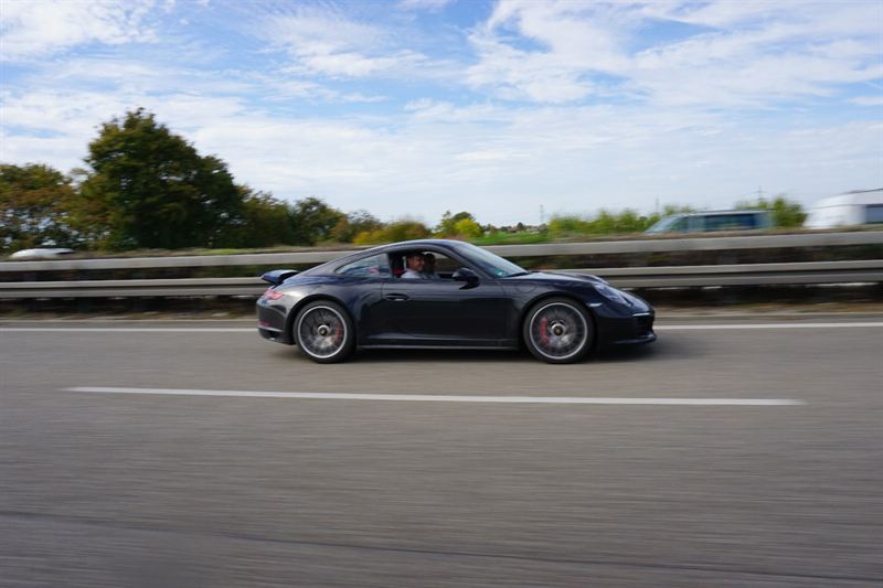 Dark Porsche 911 in motion on the German Autobahn